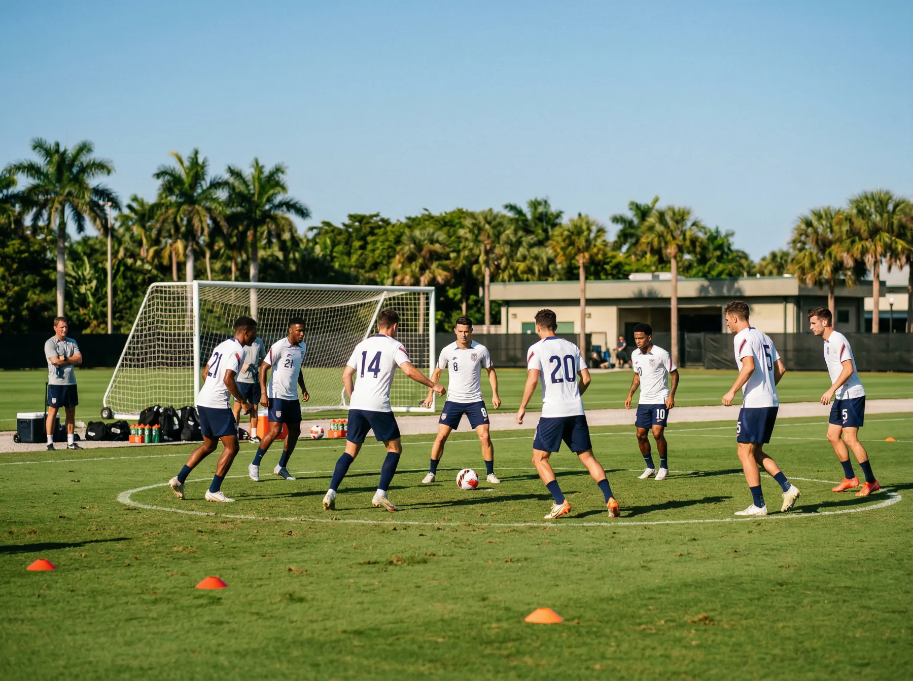 Football players in white jerseys training on a sunlit pitch before a major international tournament